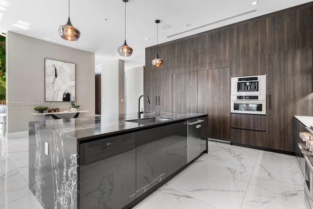 kitchen featuring a spacious island, sink, dark brown cabinets, pendant lighting, and stainless steel appliances