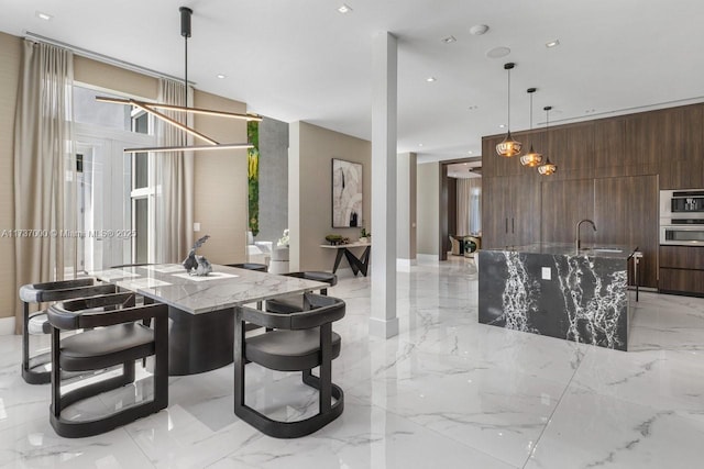 dining area featuring sink and wood walls