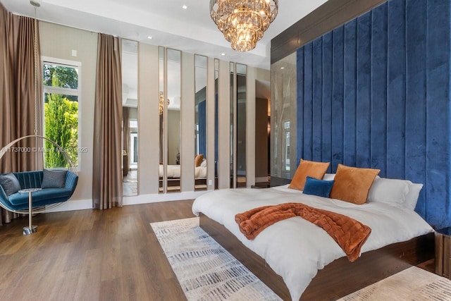 bedroom featuring an inviting chandelier and hardwood / wood-style floors