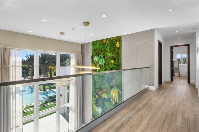 hallway with light hardwood / wood-style floors