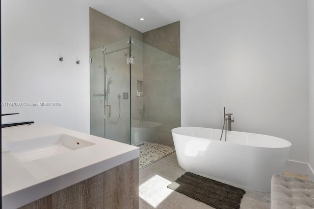 bathroom featuring vanity and separate shower and tub