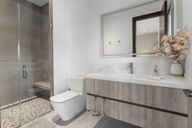 bathroom with vanity, toilet, and a shower with shower door