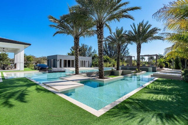 view of swimming pool featuring a lawn and a hot tub