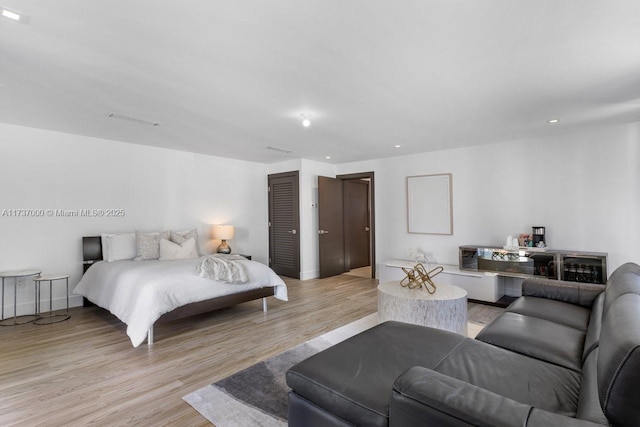 bedroom featuring a closet and light hardwood / wood-style flooring