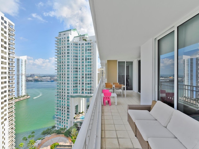 balcony featuring a water view and outdoor lounge area