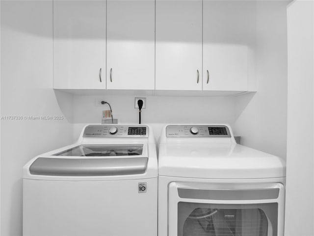 laundry area featuring cabinets and washing machine and dryer