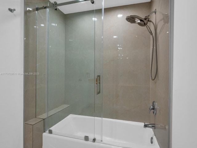 bathroom with bath / shower combo with glass door