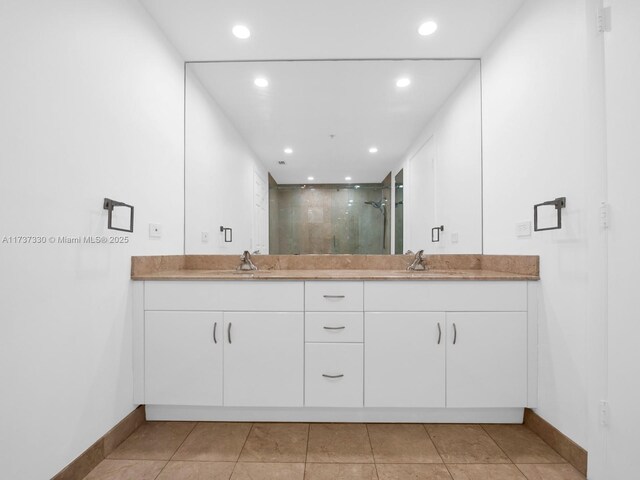 bathroom featuring vanity, tile patterned flooring, and walk in shower