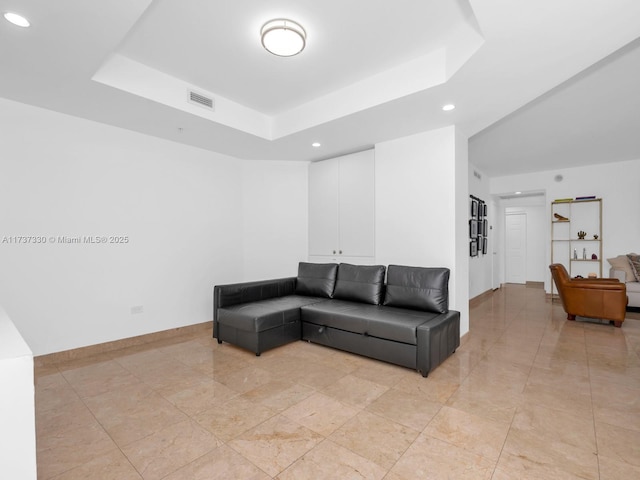 living room featuring a tray ceiling