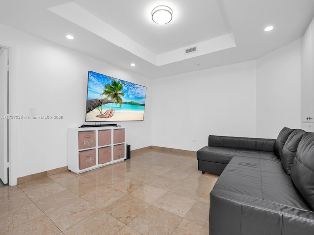 living room featuring a raised ceiling