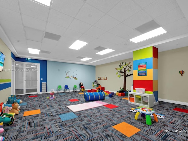 rec room with a drop ceiling and carpet flooring