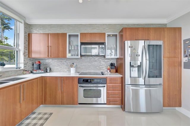 kitchen with backsplash, ornamental molding, stainless steel appliances, and sink