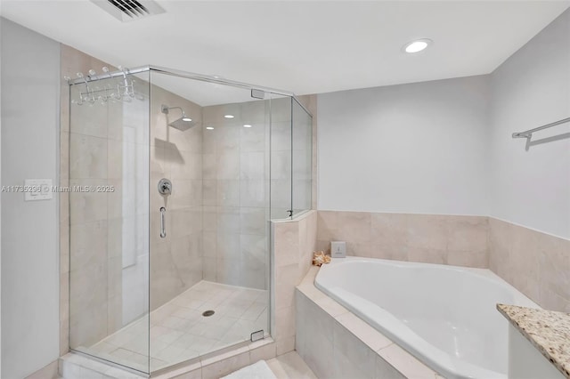 bathroom featuring separate shower and tub