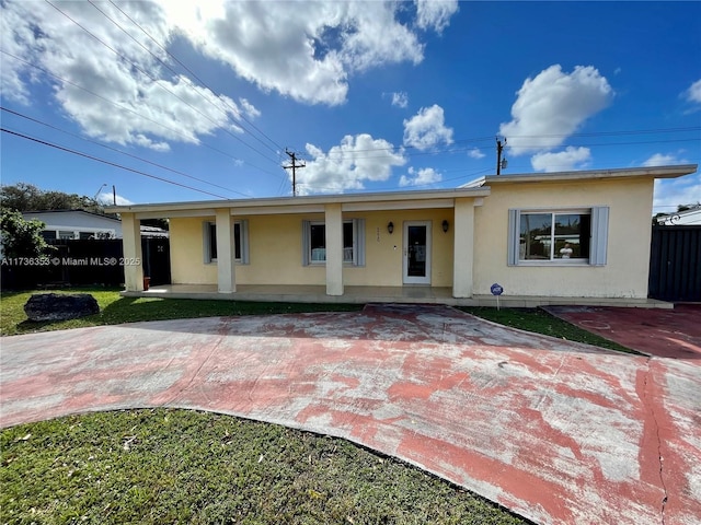 single story home with a porch, fence, and stucco siding