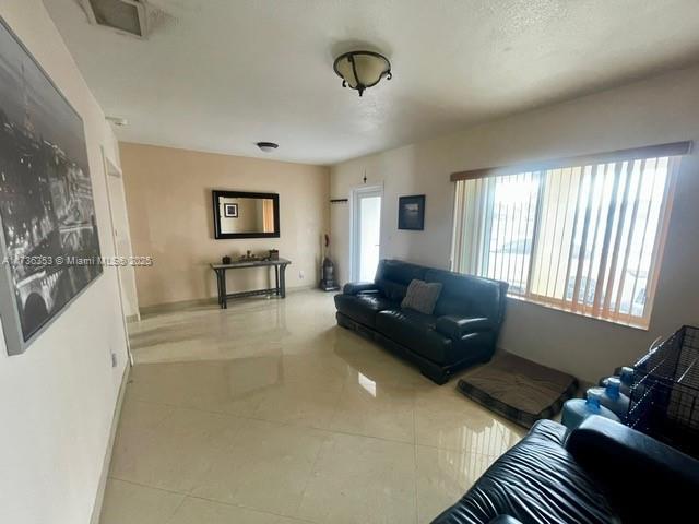 living room with tile patterned flooring