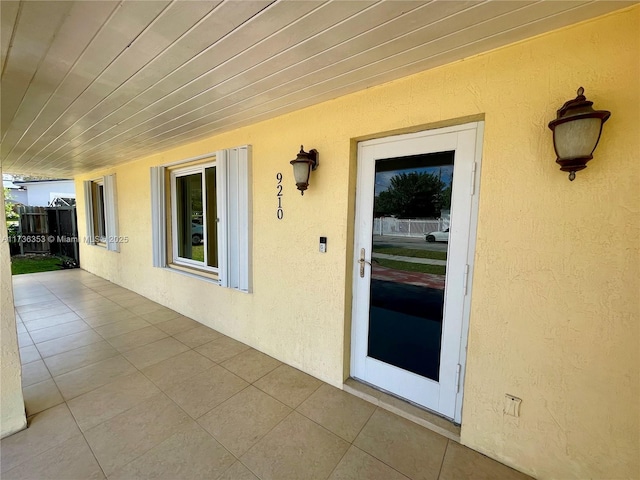 doorway to property featuring a patio and stucco siding