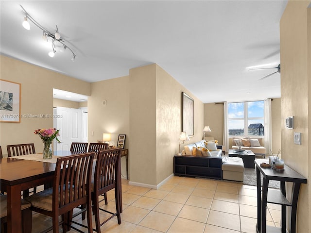 dining room featuring light tile patterned floors, track lighting, and ceiling fan