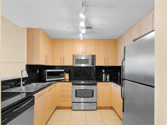 kitchen featuring sink, backsplash, light tile patterned floors, stainless steel appliances, and light brown cabinets