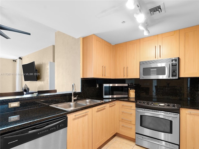 kitchen with tasteful backsplash, sink, light tile patterned floors, stainless steel appliances, and light brown cabinets