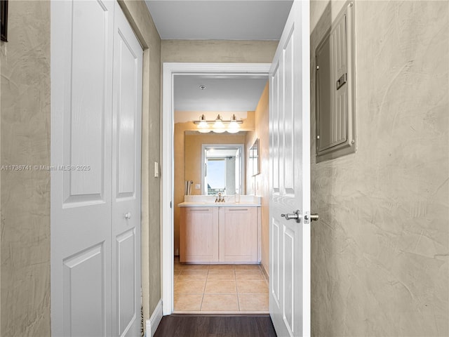 corridor featuring sink and light hardwood / wood-style floors