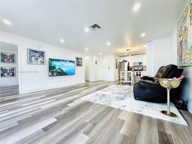 living room with light hardwood / wood-style floors