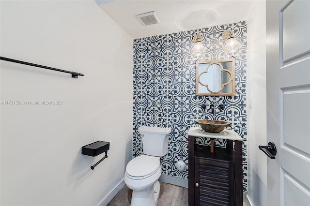 bathroom with vanity, hardwood / wood-style floors, and toilet