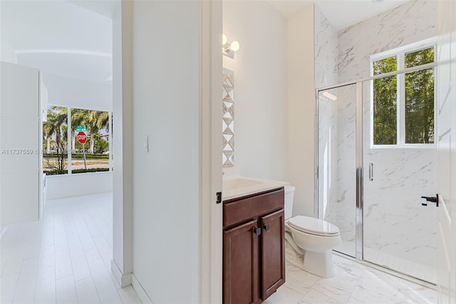 bathroom featuring vanity, toilet, and walk in shower