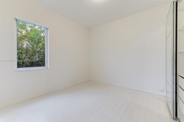 spare room with light hardwood / wood-style floors