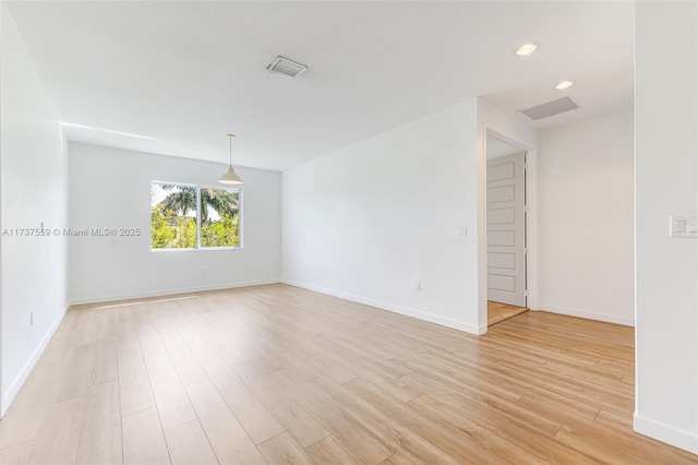 spare room with light hardwood / wood-style floors