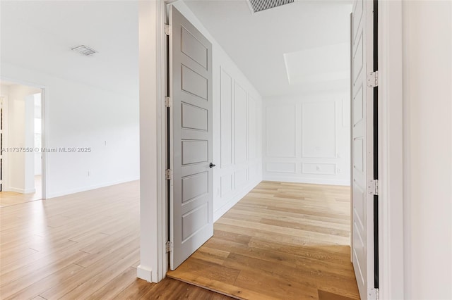 hall with light hardwood / wood-style flooring