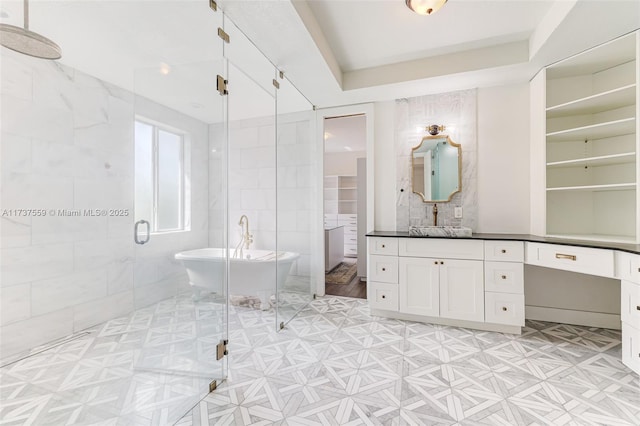 bathroom with tile walls, vanity, and independent shower and bath