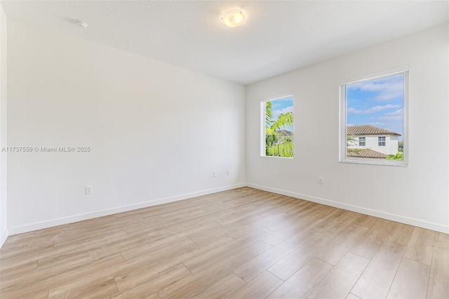 unfurnished room with light hardwood / wood-style flooring