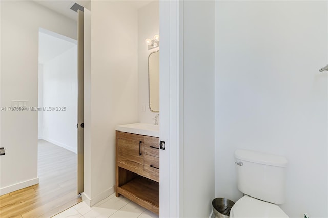 bathroom featuring vanity, toilet, and wood-type flooring