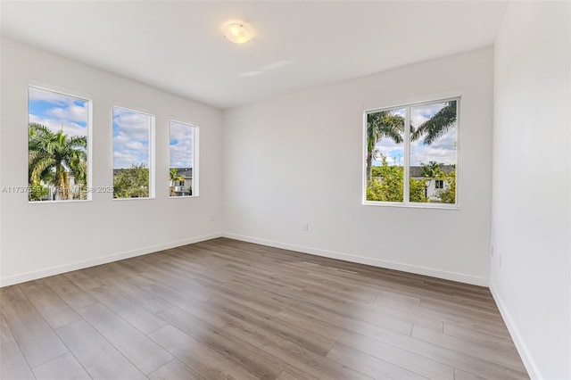 unfurnished room with light hardwood / wood-style flooring