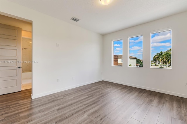 unfurnished room with light hardwood / wood-style floors