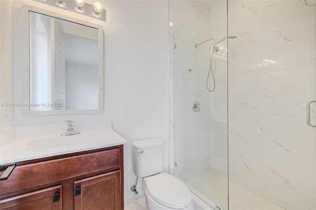 bathroom featuring vanity, toilet, and an enclosed shower