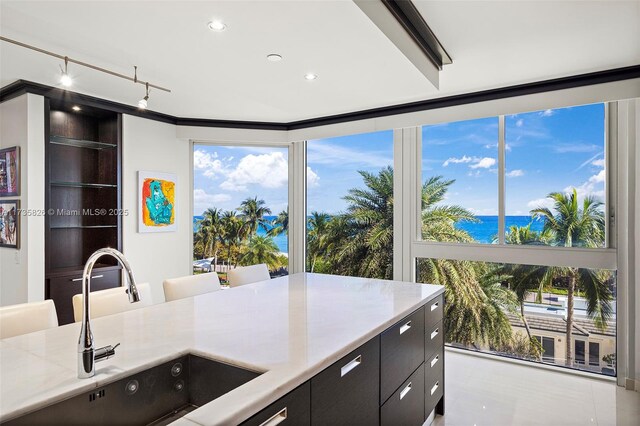 4775 Collins Ave Unit 501, Miami Beach, FL 33140 - kitchen featuring a sink, a water view, light countertops, track lighting, and floor to ceiling windows