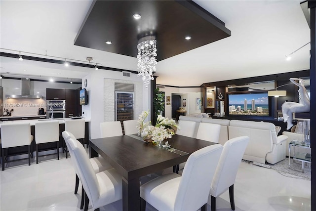 dining room featuring a raised ceiling and an inviting chandelier