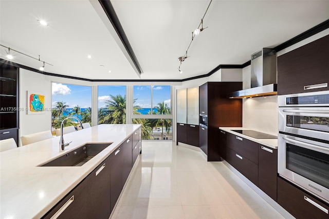 kitchen featuring sink, double oven, black electric stovetop, ornamental molding, and wall chimney exhaust hood