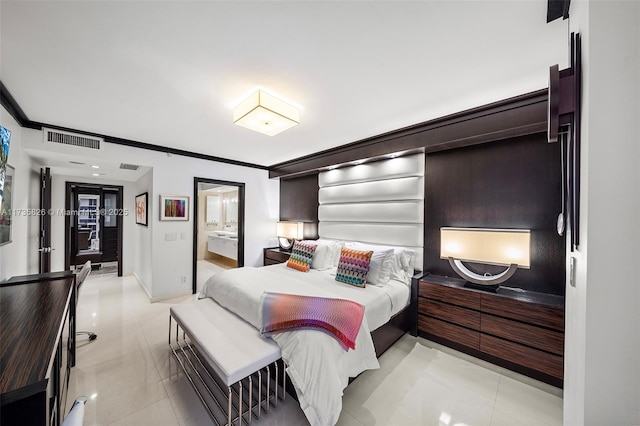 tiled bedroom with crown molding and ensuite bathroom