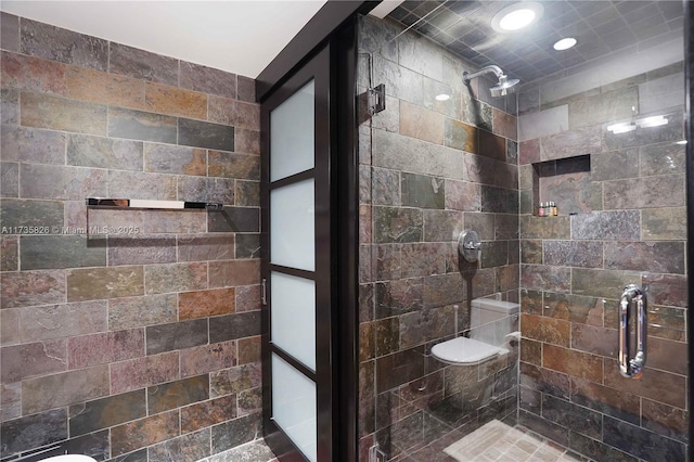 bathroom with a shower with door