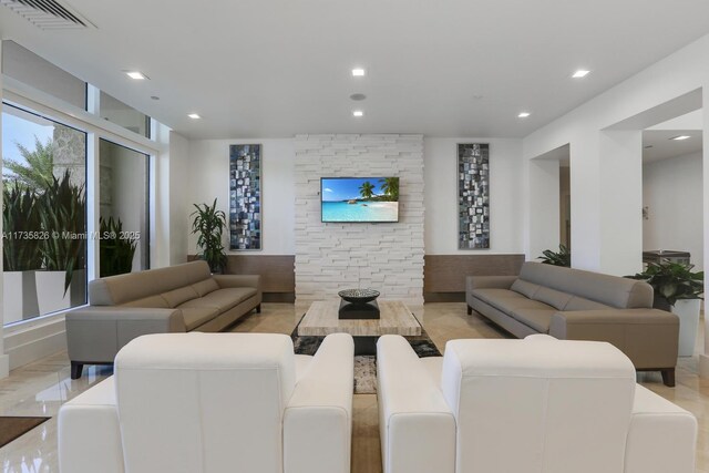 exercise room with a high ceiling, a paneled ceiling, and light hardwood / wood-style floors