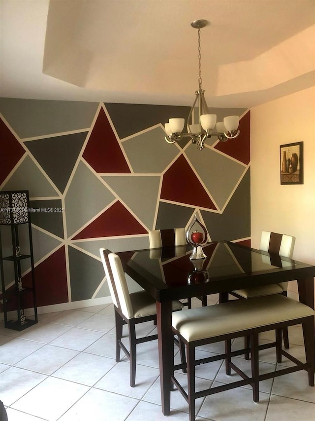 tiled dining space featuring a chandelier