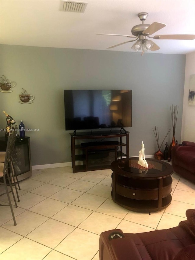 tiled living room featuring ceiling fan