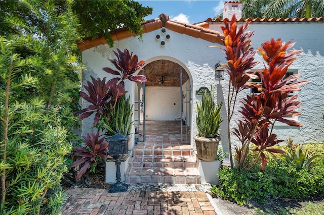 2424 Prairie Ave, Miami Beach, FL 33140 - view of exterior entry with stucco siding and a tiled roof