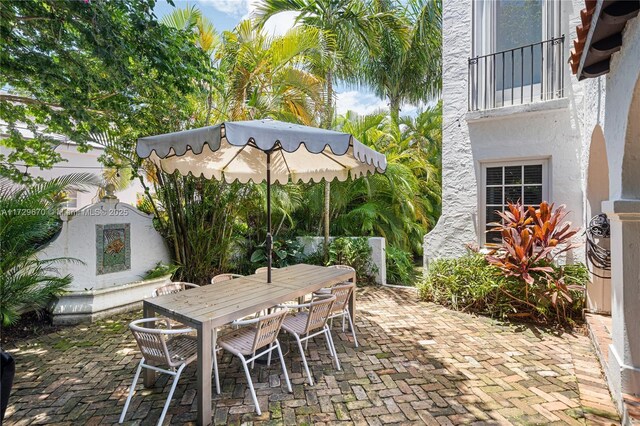 2424 Prairie Ave, Miami Beach, FL 33140 - view of patio / terrace featuring exterior fireplace and outdoor dining area