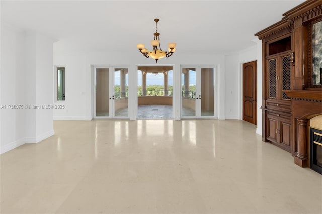 interior space featuring ornamental molding, an inviting chandelier, and french doors