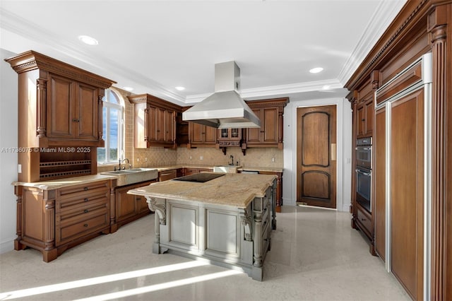 kitchen with a kitchen breakfast bar, a center island, light stone counters, island range hood, and ornamental molding