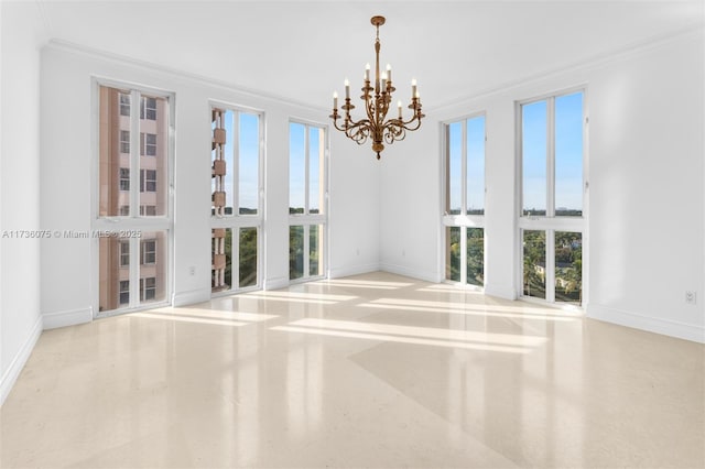 unfurnished room featuring an inviting chandelier, crown molding, and plenty of natural light