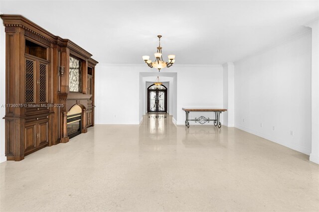 unfurnished room featuring ornamental molding, plenty of natural light, and an inviting chandelier